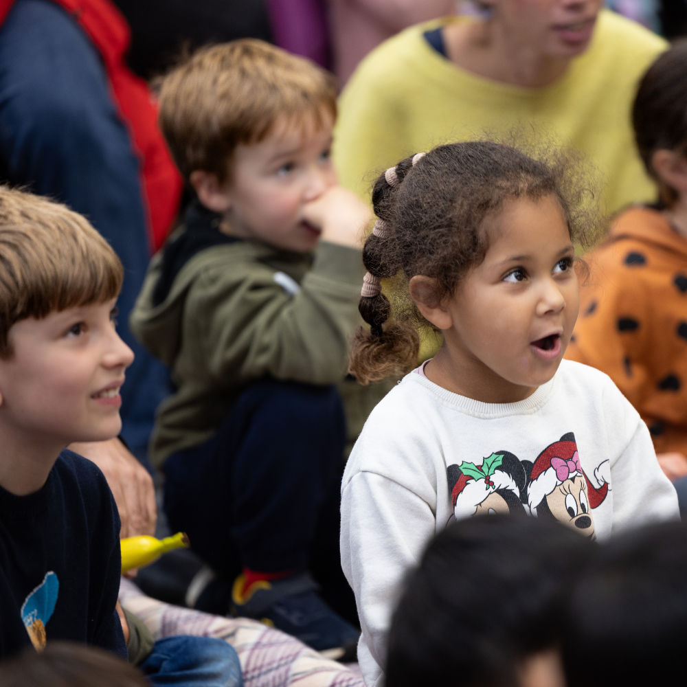 A group of engaged children sit