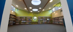 Inside the children's library at Honiton Library, redecorated in light green, high ceiling and circular windows