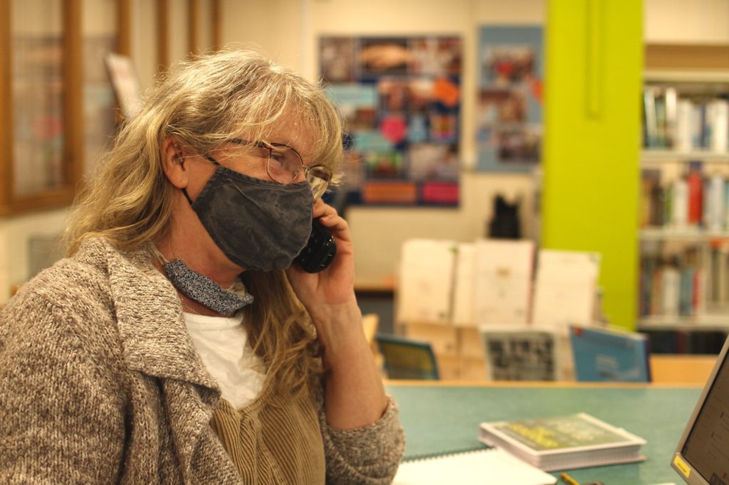 a member of our library team answering phone during lockdown